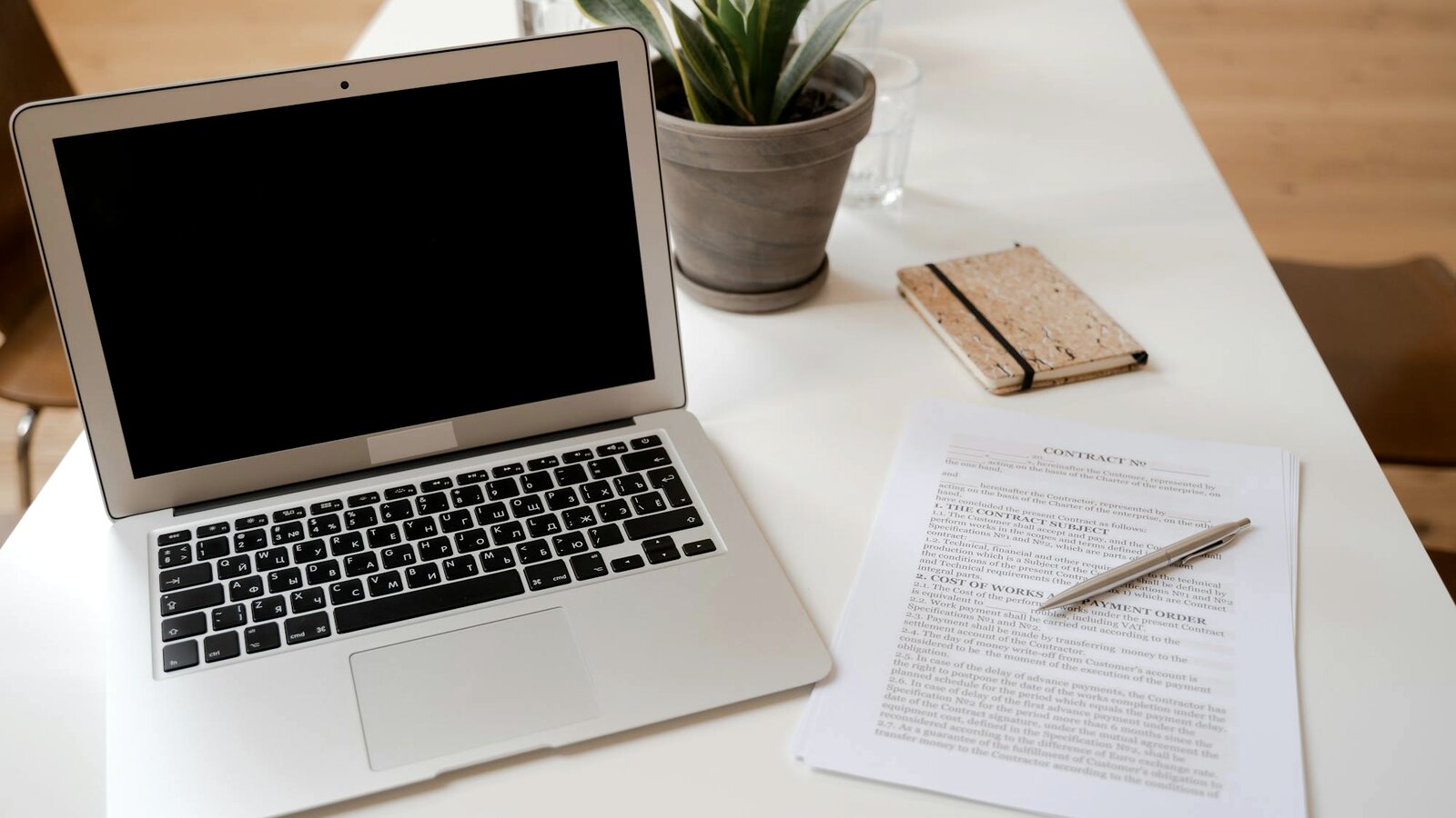 A laptop and documents on a workspace desk — placeholder stock image; real Butcher office shot pending